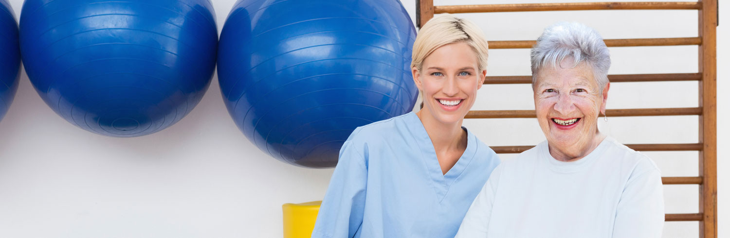Portrait of nurse and patient in rehabilitation gym.